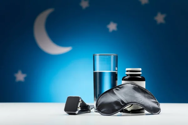 Water, eye sleeping mask, smart watch and medicine — Stockfoto