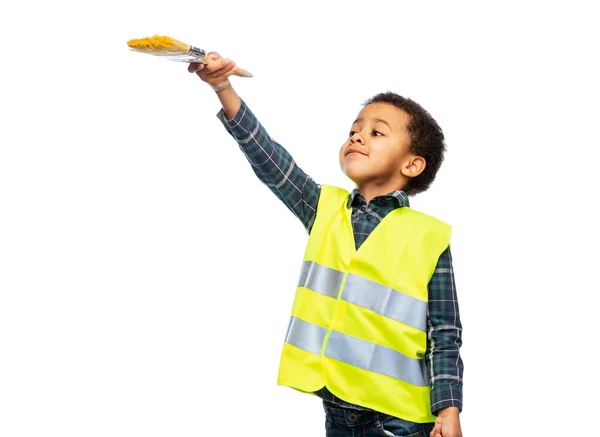 Little boy in safety vest with paint brush — Stock Fotó