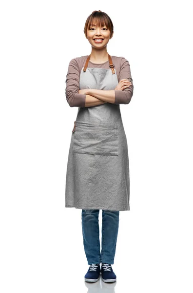 Smiling woman in apron with crossed arms — 图库照片