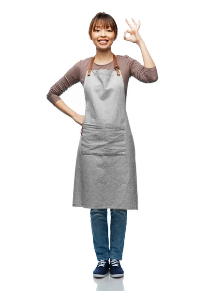 Smiling woman in apron showing ok hand sign — Stock Fotó