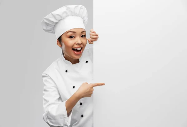 Smiling female chef with white board — Stockfoto