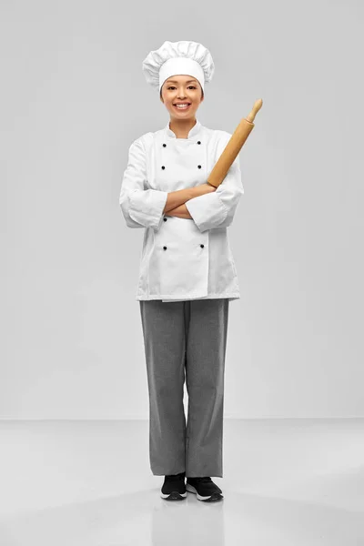 Souriant femme chef ou boulanger avec rouleau à pâtisserie — Photo