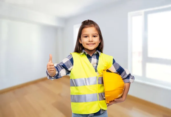 Girl with helmet and safety vest shows thumbs up — Fotografia de Stock