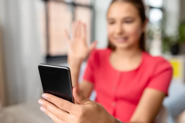 Teenage girl with smartphone having video call — Stock Photo, Image