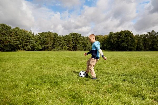 Happy little boy with ball playing soccer at park — Stock Photo, Image