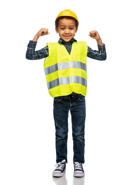 Little boy in safety vest and helmet showing power — Zdjęcie stockowe