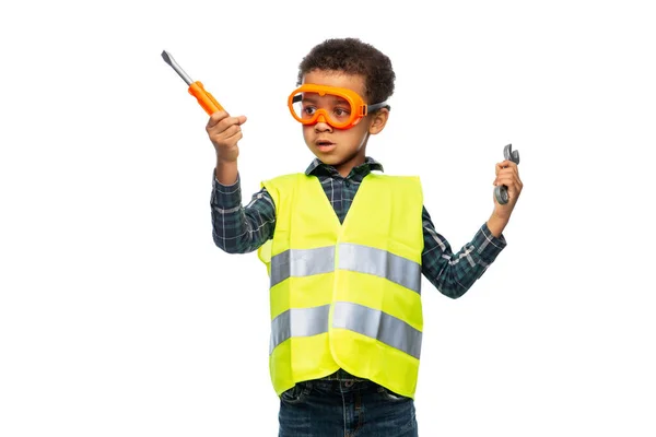 Little boy in safety vest with screwdrivers — Stockfoto