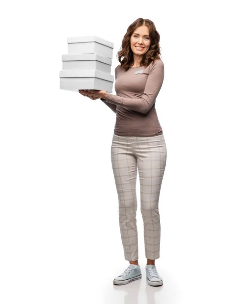 Happy female shop assistant holding shoe boxes — Stock Photo, Image