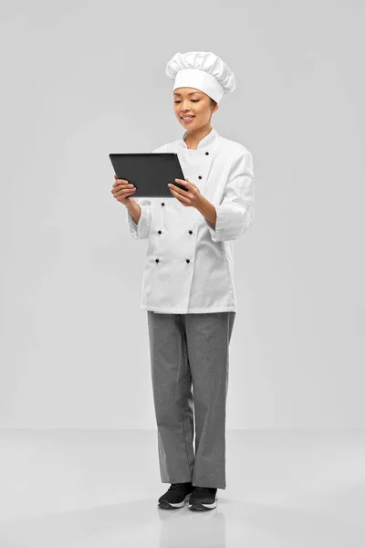 Smiling female chef with tablet computer — Stockfoto