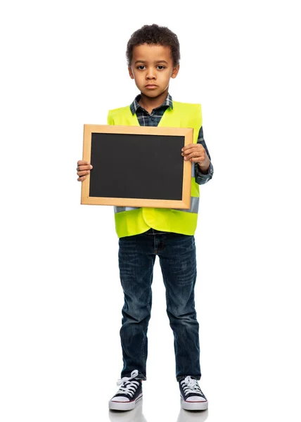 Little boy in safety vest over white background — 图库照片