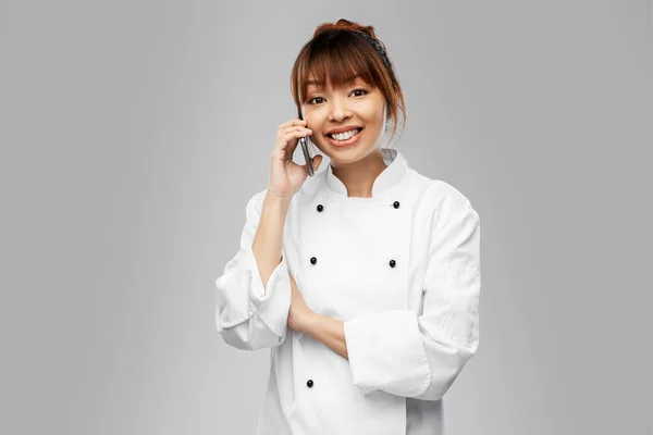 Happy female chef calling on phone — Stock Photo, Image