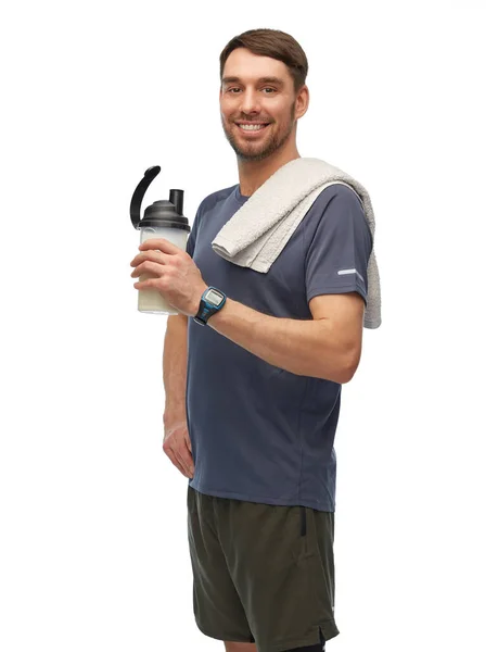 Šťastný muž ve sportovním oblečení s lahví a ručníkem — Stock fotografie