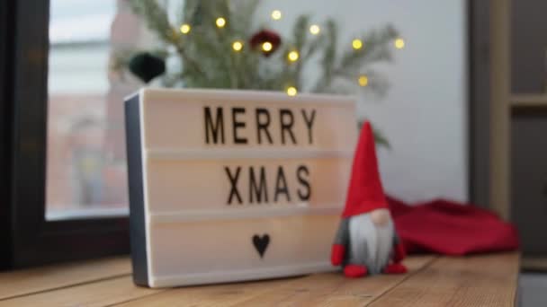 Wesołych Świąt na jasnym pudełku i krasnalu na oknie — Wideo stockowe