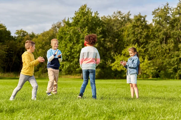 Crianças felizes brincando e correndo no parque — Fotografia de Stock