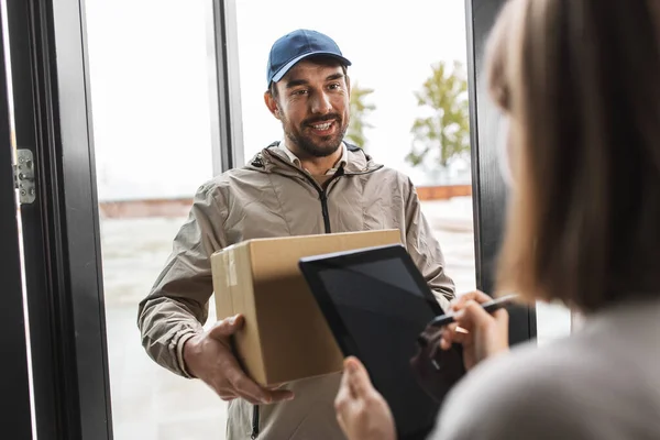 Repartidor hombre con caja y mujer firma forma digital — Foto de Stock