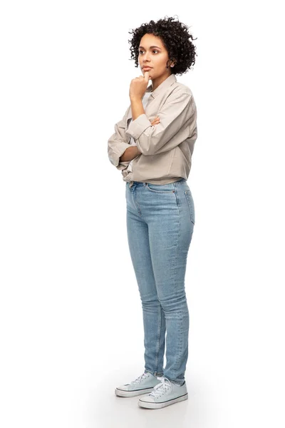 Thinking woman in shirt and jeans — Stock Photo, Image