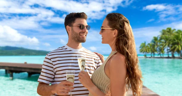 Feliz pareja bebiendo champán en verano playa — Foto de Stock