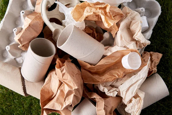 Close up of crumpled paper waste on grass — Stock Photo, Image