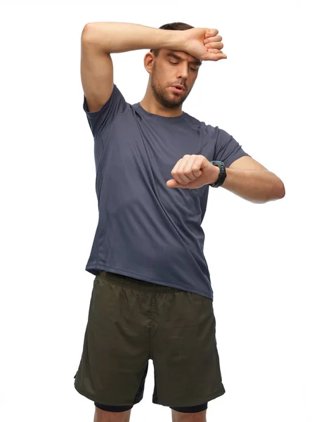 Tired man with smart watch or fitness tracker — Stock Photo, Image