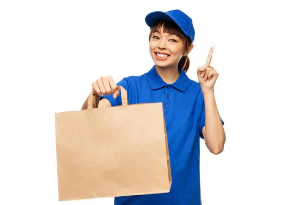 Delivery woman with takeaway food in paper bag — Stock Photo, Image