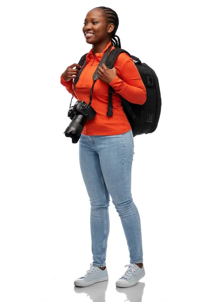 デジタルカメラとバックパックを持った笑顔の女性 — ストック写真