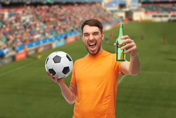 Happy football fan with soccer ball and beer — Stock Photo, Image