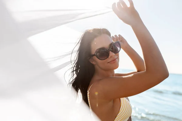 Woman in bikini swimsuit with cover-up on beach — Stock Photo, Image