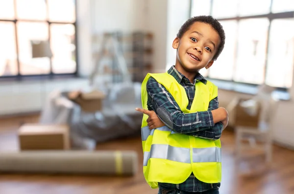 Boy in safety vest with crossed arms at home — Stock Photo, Image