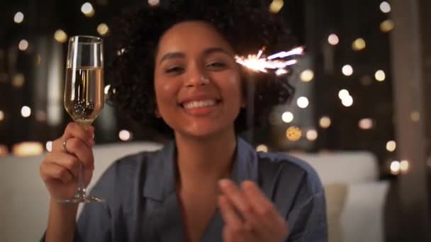 Happy woman with champagne and sparkler at night — Stock Video