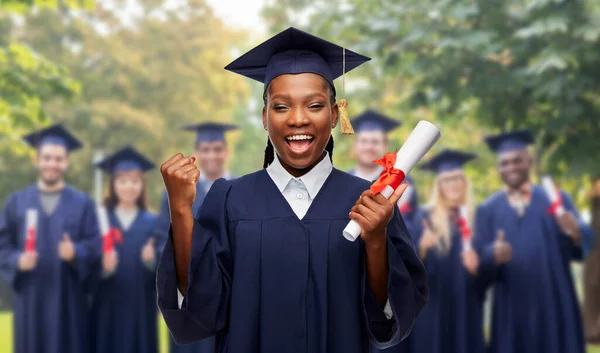 Happy female graduate student with diploma — Stock Photo, Image