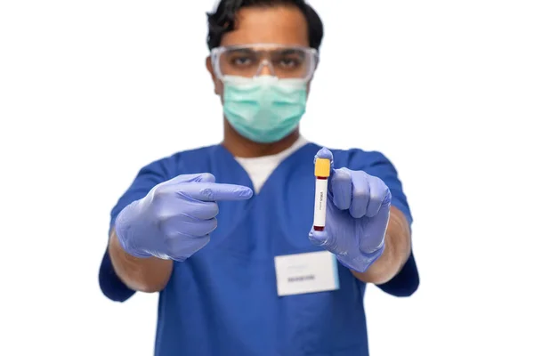 Male doctor in mask with blood in test tube — Stock Photo, Image