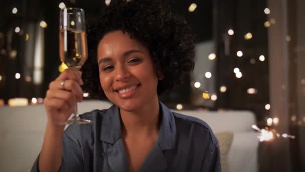 Счастливая женщина с шампанским и искрой по ночам — стоковое видео
