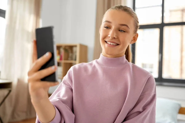 Boldog lány smartphone csinál selfie otthon — Stock Fotó