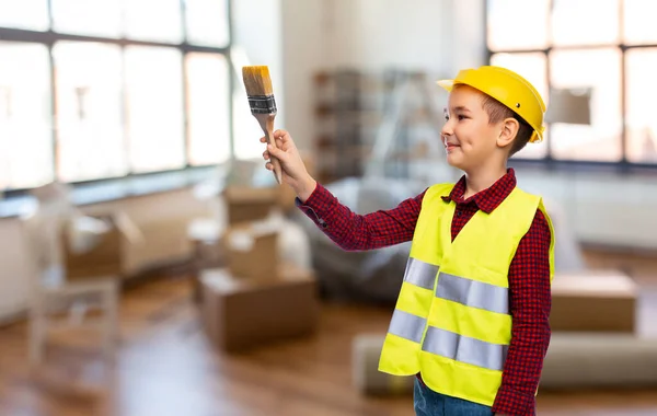 Little boy in protective helmet with brush — Stock Photo, Image