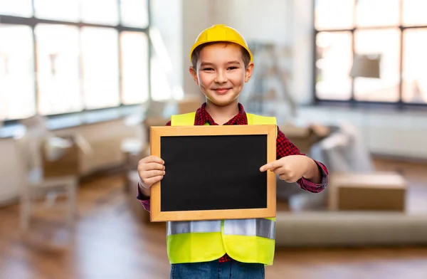 Little boy in protective helmet holding chalkboard — Stock Photo, Image
