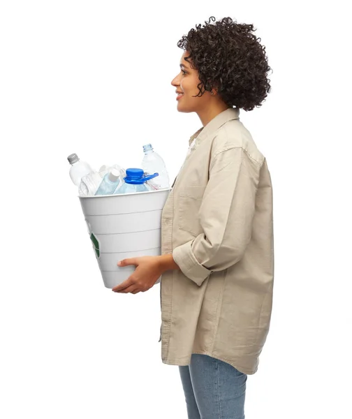 Smiling young woman sorting plastic waste — Stock Photo, Image