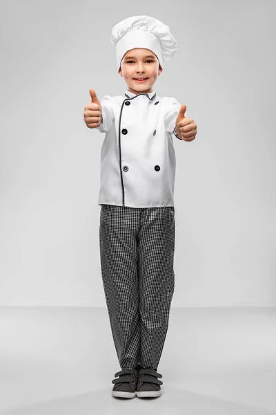 Bambino in chefs toque mostrando pollici in su — Foto Stock