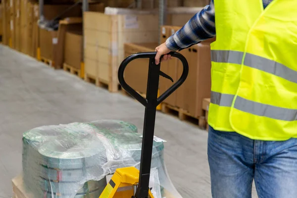 Man with loader working at warehouse — Stock Photo, Image