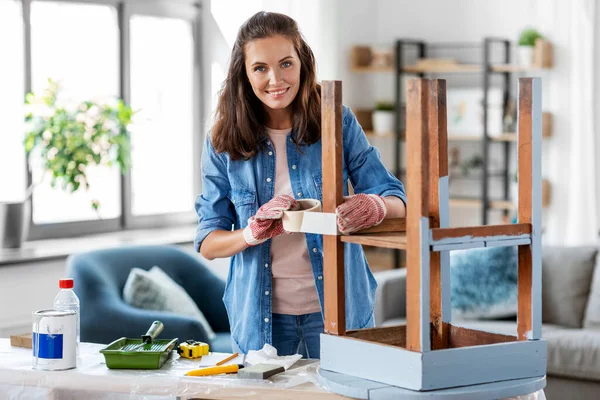Woman sticking masking tape to table for repaint — Stock Photo, Image