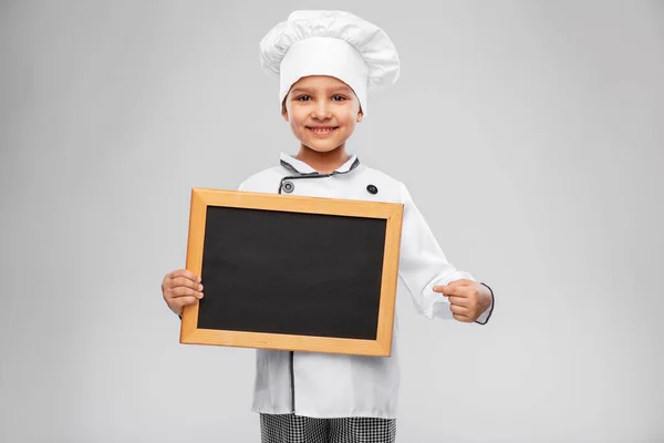 Menina feliz em chefs toque com quadro — Fotografia de Stock