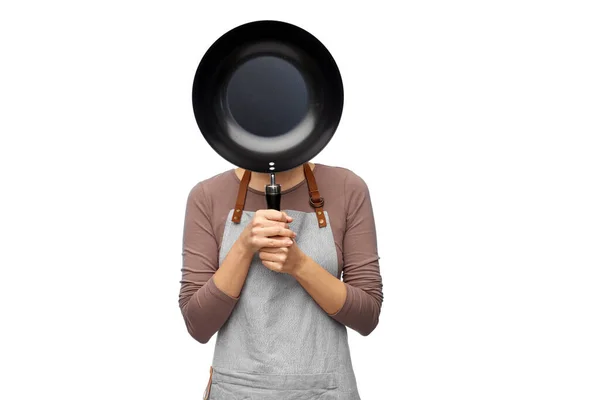 Female chef hiding face behind frying pan — Stock Photo, Image