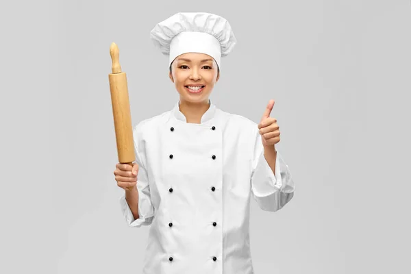 Smiling female chef or baker with rolling pin — Stock Photo, Image