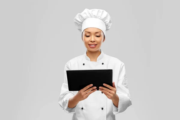 Smiling female chef with tablet computer — Stockfoto