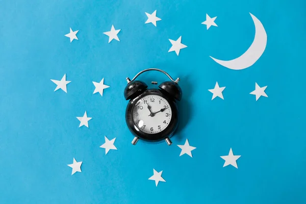 Alarm clock on blue night background — Stock Photo, Image