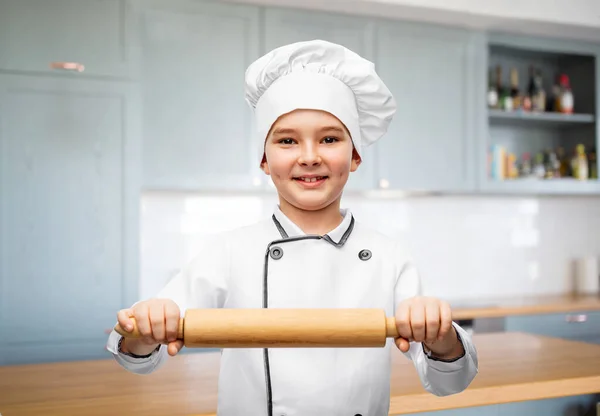 Smiling boy in chefs toque with rolling pin — Stock Photo, Image