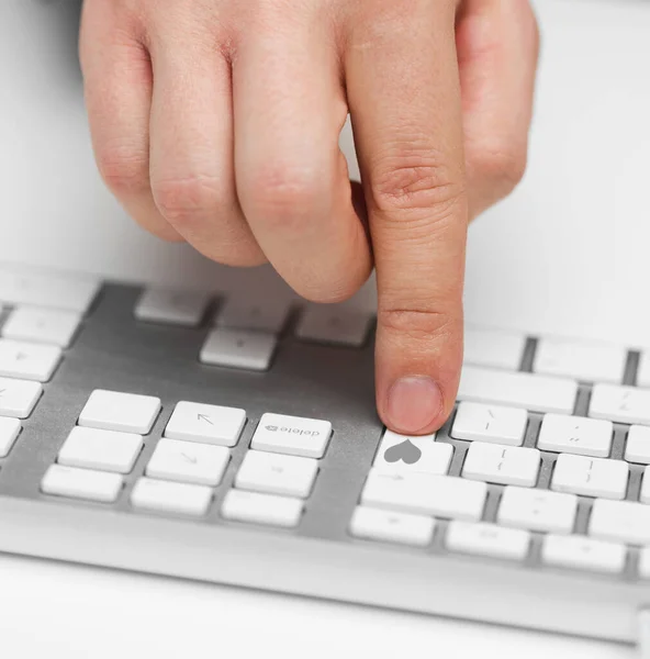 Hand pressing button with heart on white keyboard — Stock Photo, Image