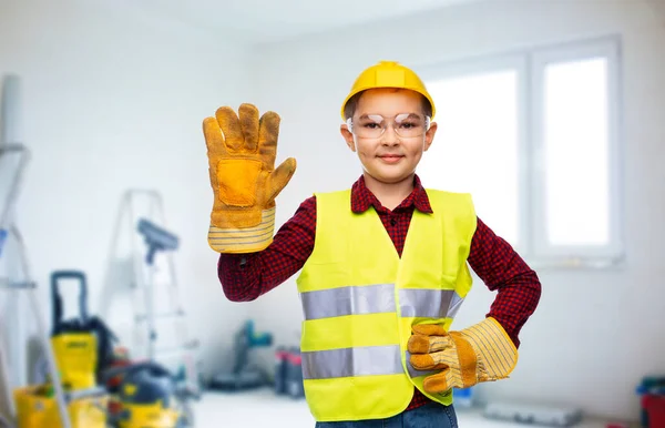 boy in protective helmet, gloves and safety vest