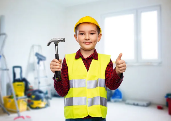 Boy in helmet with hammer showing thumbs up — Stock Photo, Image