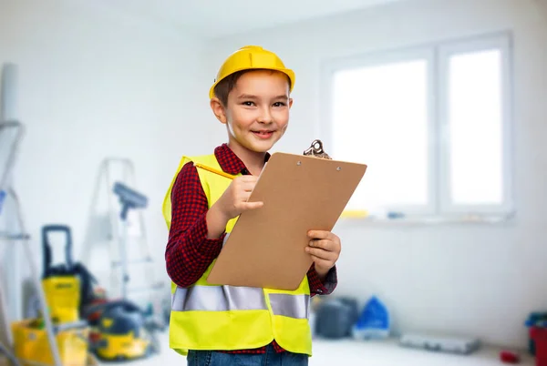 Little boy in helmet with clipboard and pencil — Stock Photo, Image