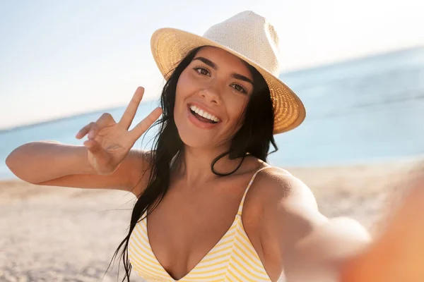 Glimlachende vrouw in bikini selfie nemen op het strand — Stockfoto